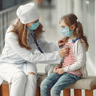 Pediatrician examining child with limited healthcare options.